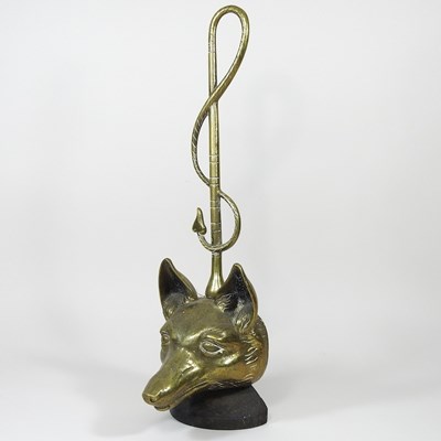 Lot 23 - A brass doorstop