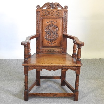 Lot 57 - A carved oak wainscot chair