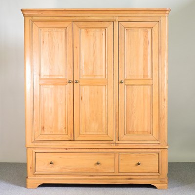 Lot 502 - A light oak triple wardrobe