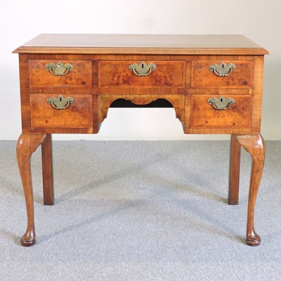 Lot 84 - An 18th century style walnut lowboy