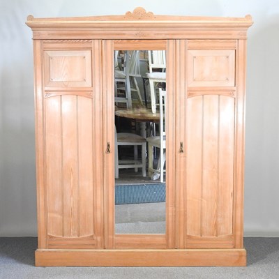 Lot 621 - An Edwardian light ash triple wardrobe, with a...