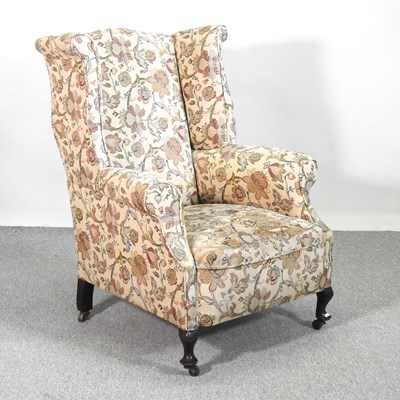 Lot 400 - A Georgian style floral upholstered wing...