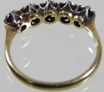 Lot 67 - An 18 carat gold and platinum set five stone...