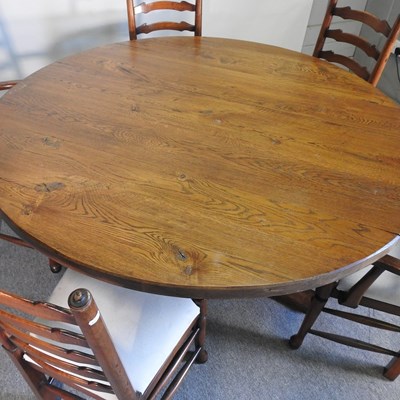Lot 105 - An oak circular dining table, 147cm diameter,...