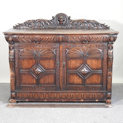 Lot 611 - An early 20th century carved oak sideboard,...