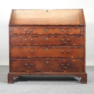 Lot 628 - A George III oak bureau, on bracket feet