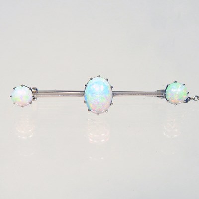 Lot 214 - A 15 carat gold three stone opal bar brooch,...