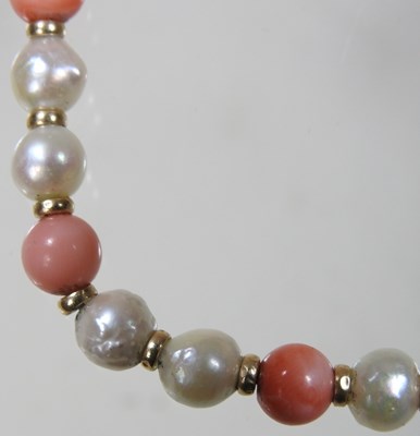 Lot 99 - A coral and cultured pearl bead necklace, with...