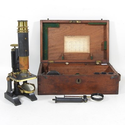 Lot 11 - An early 20th century microscope, 27cm high,...