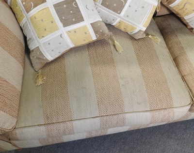 Lot 66 - A modern gold striped upholstered sofa, with...