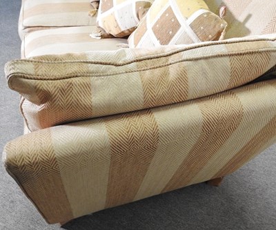Lot 66 - A modern gold striped upholstered sofa, with...