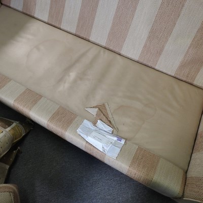 Lot 66 - A modern gold striped upholstered sofa, with...