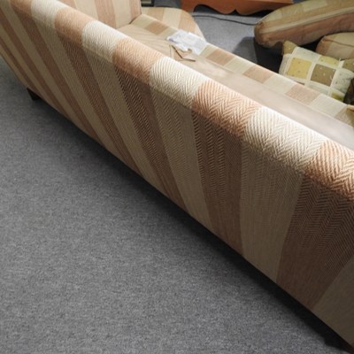 Lot 66 - A modern gold striped upholstered sofa, with...