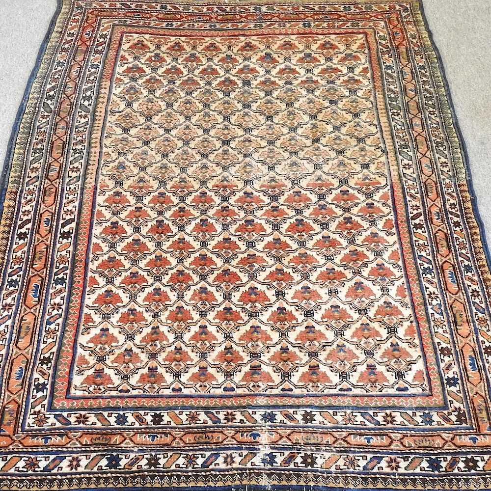 Lot 46 - A Persian carpet, with all over flowerhead...