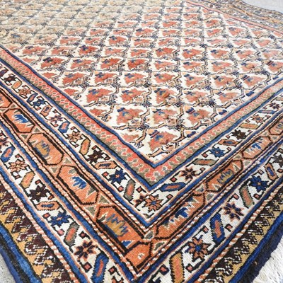 Lot 46 - A Persian carpet, with all over flowerhead...