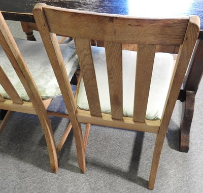 Lot 175 - An oak dining table, together with a set of...
