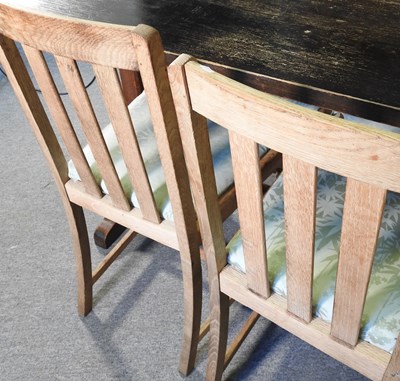 Lot 175 - An oak dining table, together with a set of...