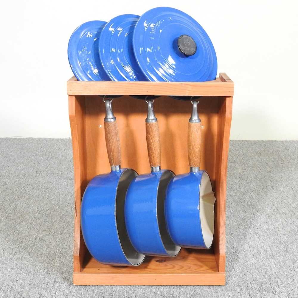 Lot 16 - A set of three graduated Le Creuset saucepans,...