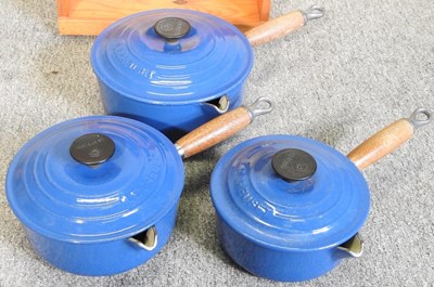 Lot 16 - A set of three graduated Le Creuset saucepans,...