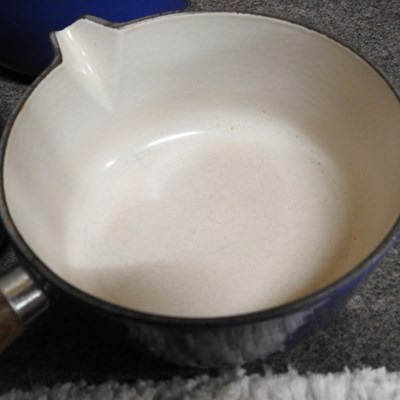 Lot 16 - A set of three graduated Le Creuset saucepans,...