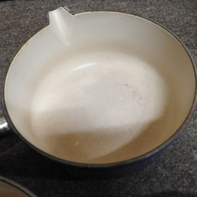 Lot 16 - A set of three graduated Le Creuset saucepans,...