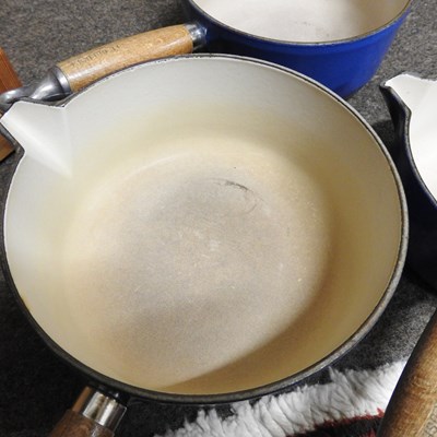 Lot 16 - A set of three graduated Le Creuset saucepans,...