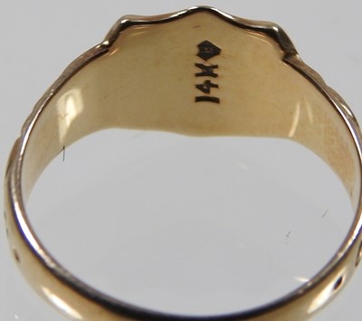 Lot 15 - A 9 carat gold signet ring, the central shield...