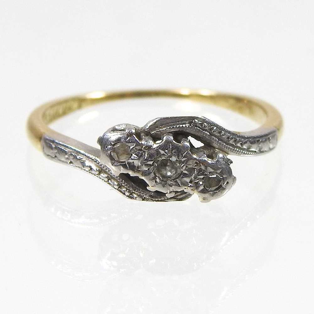 Lot 101 - An 18 carat gold and platinum set three stone...
