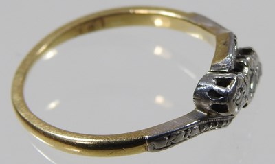 Lot 101 - An 18 carat gold and platinum set three stone...