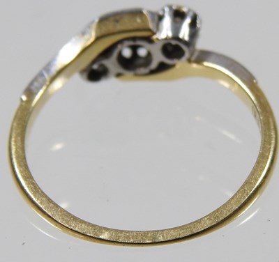 Lot 101 - An 18 carat gold and platinum set three stone...
