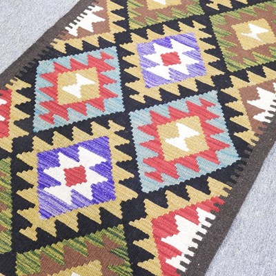 Lot 87 - A kilim runner, with rows of coloured diamonds,...