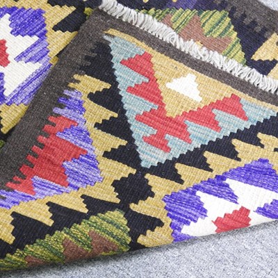 Lot 87 - A kilim runner, with rows of coloured diamonds,...