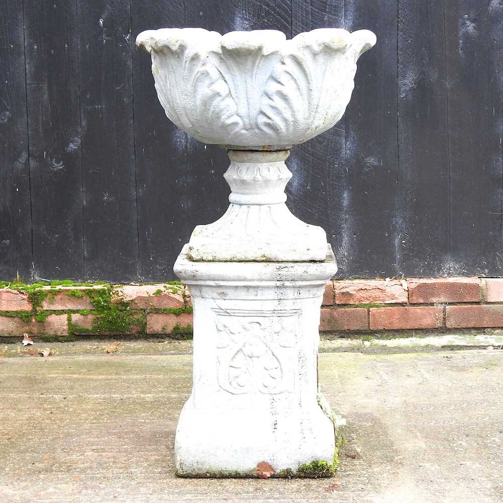 Lot 5 - A cast stone garden urn, on a plinth base,...
