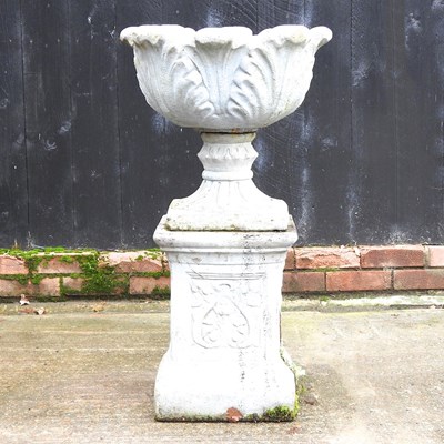 Lot 5 - A cast stone garden urn, on a plinth base,...