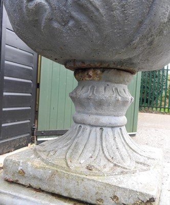 Lot 5 - A cast stone garden urn, on a plinth base,...
