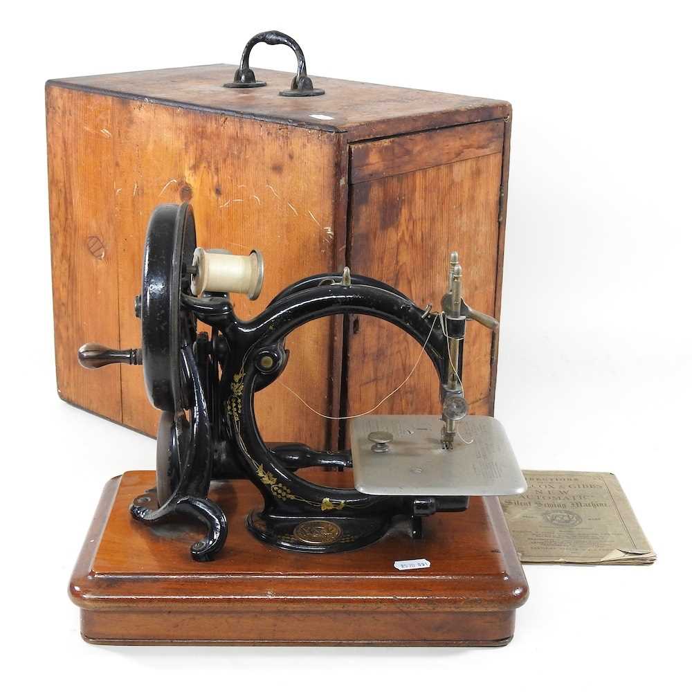 Lot 22 - A 19th century Willcox & Gibbs sewing machine,...