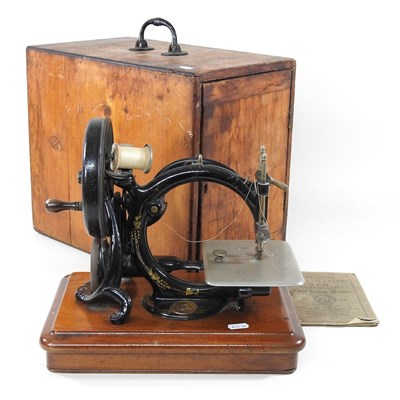 Lot 22 - A 19th century Willcox & Gibbs sewing machine,...