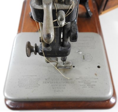 Lot 22 - A 19th century Willcox & Gibbs sewing machine,...