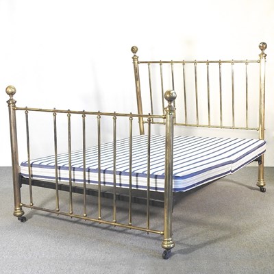 Lot 560 - An early 20th century brass bed, with a sprung...