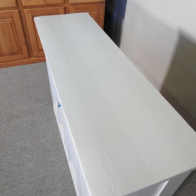 Lot 76 - A blue painted pine dresser base, on a plinth...