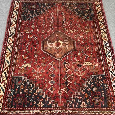 Lot 552 - A Persian rug, with a central hooked medallion,...