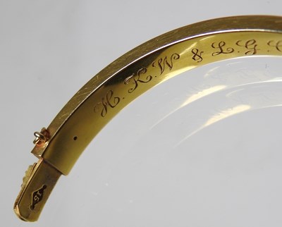 Lot 1 - An Edwardian 14 carat gold bangle, of hinged...