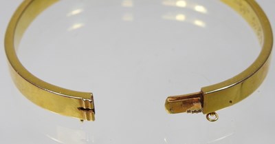 Lot 1 - An Edwardian 14 carat gold bangle, of hinged...
