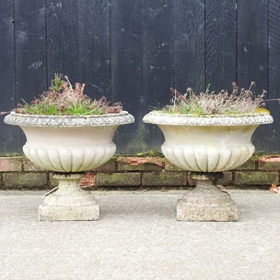 Lot 490 - A pair of cast stone garden urns, of campana...