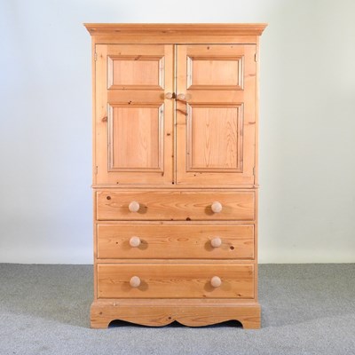 Lot 513 - A pine cabinet, enclosed by panelled doors,...