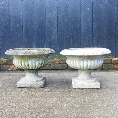 Lot 43 - A pair of small cast stone garden urns, on...