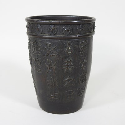 Lot 766 - A Chinese bronze beaker, decorated in relief...