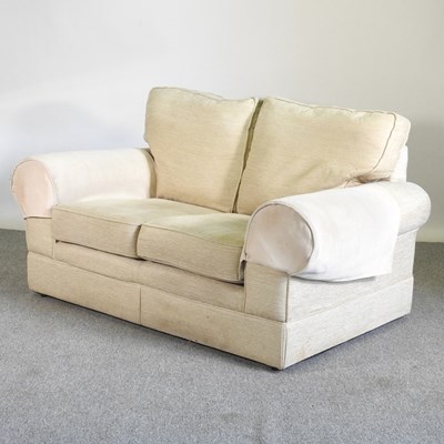 Lot 497 - A modern cream upholstered two seater sofa