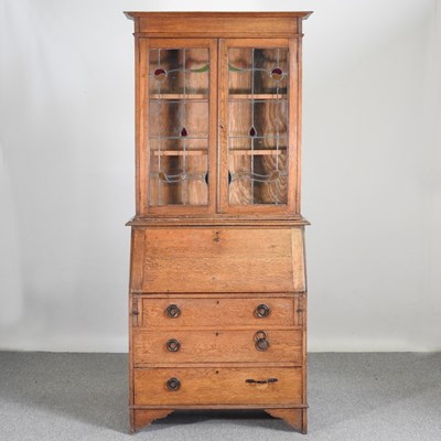 Lot 771 - An early 20th century oak bureau bookcase,...