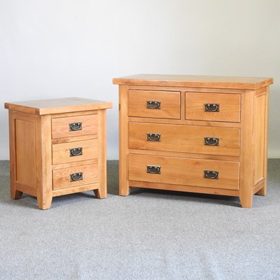 Lot 495 - A modern light oak chest of drawers, together...
